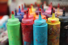 Bottles Of Colorful Paint In An Artist's Studio
