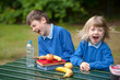 © Lee Avison Photography/Stocksy - two children in school uniform