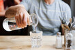 © Suzi Marshall/Stocksy - Man pouring water into a glass at a restaurant