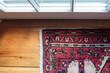 © Holly Clark/Stocksy - Looking down on a woman's feet standing on an oriental carpet.