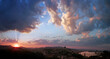 © Ferenc Boros/Stocksy - Setting sun with glowing clouds above Budapest
