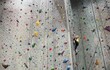 © Carolyn Lagattuta/Stocksy - Young girl climbing to the top of a climbing rock wall