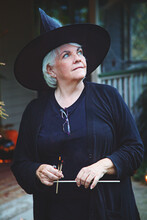 A Woman Dressed Like A Witch For Halloween