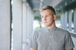 © Stephen W. Morris Photography/Stocksy - Casual Young Man Standing in Walkway