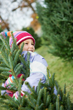 Tree Lot: Little Girl Hugs Christmas Tree