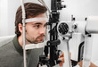 © Peakstock - Adult man getting an eye exam at ophthalmology clinic. Checking retina of a male eye close-up
