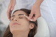 © zinkevych - Cosmetologist dying eyebrows of young woman in the salon