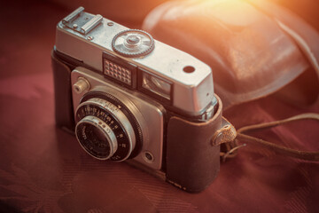 Wall Mural - Closeup dirty vintage manual camera with leather case on the countertop at the sunday flea market. Shopping at antique bazaar.