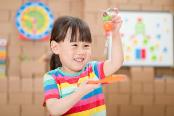 Wall Mural - young  girl  play magical magnet experiments at home for homeschooling