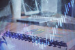 © peshkova - Double exposure of financial graph drawings and desk with open notebook background. Concept of forex market