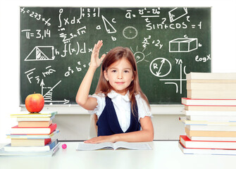 Wall Mural - Happy and cute teen schoolgirl raising hand in classroom