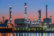 © Chatchawal - Oil refinery reflected along with river during twilight