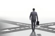 © Elnur - Young businessman at crossroads in uncertainty concept