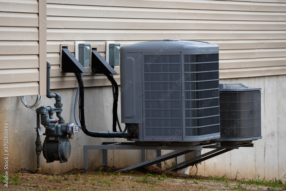 Air conditioning unit on concrete slap with new construction brick ...