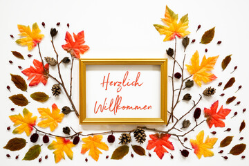 Wall Mural - golden frame with german text herzlich willkommen means welcome. beautiful, colorful autumn leaf dec