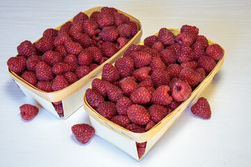 Wall Mural - Fresh raspberry in a wooden ecological container. The concept of environmental business.