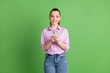 © deagreez - Photo of positive girl blogger use smartphone enjoy social network communication texting typing wear lilac denim jeans isolated over green color background
