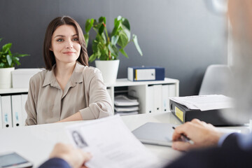 Wall Mural - Confident Caucasian woman sitting in front of professional HR manager at office desk having job interview