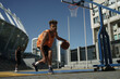 © Drobot Dean - Image of african american guy playing basketball on city sports ground