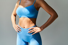 Cropped Image Of Fit Woman Torso  On Grey Background