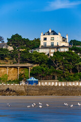 Wall Mural - Sand beach and historic villas in Dinard, a popular seaside resort on the french Atlantic ocean coast in Brittany, France.