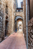 Fototapeta Na drzwi - Narrow medieval street with motorcycles in San Gimignano, Italy