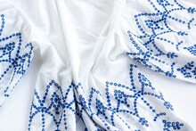 Blue Embroidered On White Ladies Summer Blouse On White Surface.