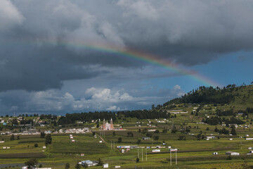 Mexico country landscape, a rainbow appearing on the horizon in front of a hill 2