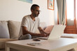 © 1 MEDIA - South european spanish man working at home using laptop