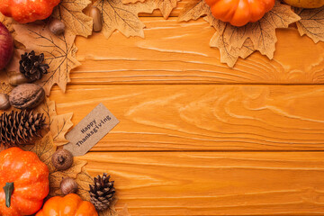 Wall Mural - top view of pumpkins, autumnal decoration and happy thanksgiving card on wooden background