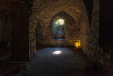 Fototapeta Desenie - Rays of light shining into the medieval cellar