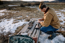 Male Hunter Preparing Rifles In Snow