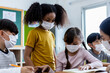 © JR-50 - Diversity of children students wearing medical masks in the classroom.