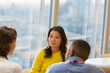 © Martin Barraud/Caia Image - Businesswoman listening to colleagues in meeting
