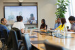 © Martin Barraud/Caia Image - Business people video conferencing in conference room meeting