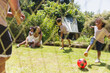 © Tom Merton/Caia Image - Happy family playing soccer in sunny summer backyard