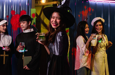 Portrait of young people dressing halloween costume and dancing in party