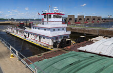 Pushing Barges:  A Towboat Moves Three Rows Of Covered Barges Through A Lock And Past A Dam On The Mississippi River.
