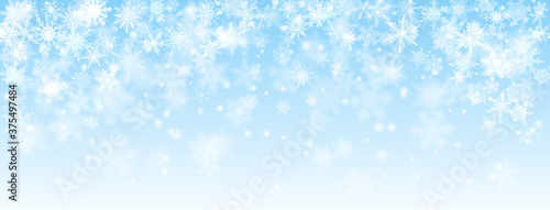 Cuadros en Lienzo Christmas background of falling snowflakes in light blue colors
