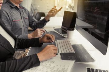 two asian team working development of programming and encryption technology website design programme