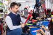 © JackF - Cheerful positive man is choosing new construction pliers in tools store.