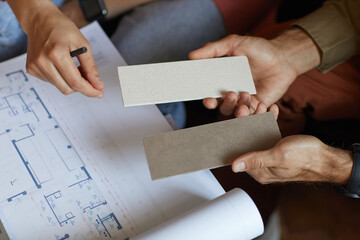 Wall Mural - close-up of people examining the blueprint and working over new project in team