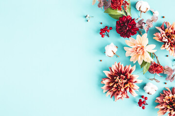 Wall Mural - Autumn composition. Dried flowers and leaves on blue background. Autumn, fall, thanksgiving day concept. Flat lay, top view