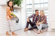 © Angelov - family mother, father and child girl little helper in laundry room near washing machine and dirty clothes