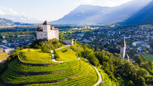 View From Drone Of Stone Gutenberg Castle On Top Of Green Hill On Background With Small Town Of Balzers, Liechtenstein