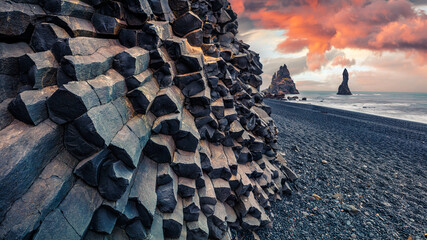 Unbelievable sunset on Reynisdrangar cliffs in Atlantic ocean. Spectacular summer scene of black sand beach in Iceland, Vik location, Europe. Beauty of nature concept background.