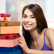 Portrait image of happy excited smiling girl with gifts boxes, at home. Shopping, sales, holidays actions, consumer credit concept - young woman with purchases posing indoors. Square composition.