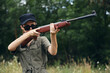 © SHOTPRIME STUDIO - Woman soldier Sunglasses weapon aiming hunting green leaves