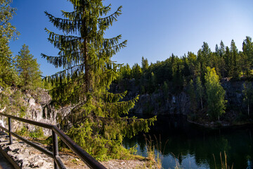 mountain lake with clear green water in granite and marble rocks in a natural monument