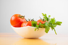 Ingredients For Salad With A Celery And Whole Tomatoes. Fresh Wet Green And Red Vegetables Isolated On White Background.